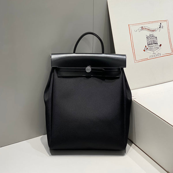 HERBAG A DOS ZIP RETOURNE BACKPACK 29 IN BLACK CANVAS AND CALFSKIN
