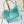 HINA 23 IN SKY BLUE MONOGRAM PERFORATED CALFSKIN