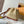 NOÉ PURSE 24 IN BEIGE CROCHETED RAFFIA AND BROWN CALFSKIN TRIM