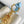 CAPUCINES NANO 16 IN PEARL WHITE MIX SKY BLUE TAURILLON GOLD HARDWARE
