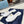 PRA SAFFIANO PATENT SLIDES OSTRICH MOTIF WHITE CALFSKIN