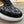 LV TRAINER IN BLACK EMBOSSED CALFSKIN AND MONOGRAM FABRIC