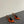 RED GEM-STUDDED SLINGBACK PUMPS IN ORANGE PATENT CALFSKIN