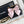 CC MINI 13 CLUTCH WITH STRAP IN BLACK LAMBSKIN AND PINK BOW